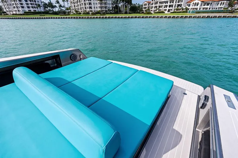 Daddy Yacht Photos Pics Luxury VanDutch 55 yacht with turquoise seating, cruising near waterfront buildings.