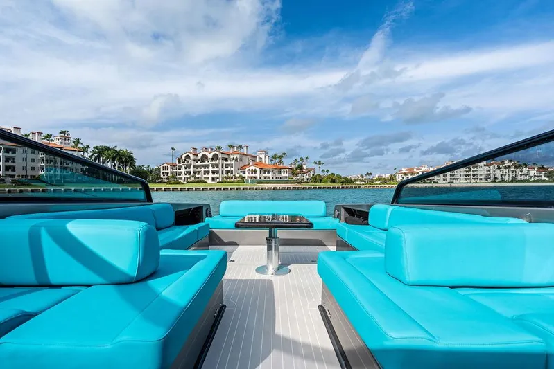 Daddy Yacht Photos Pics Luxurious 2015 VanDutch 55 yacht with turquoise seating, cruising near waterfront properties.