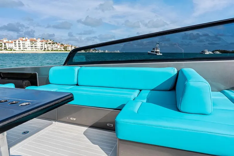 Daddy Yacht Photos Pics VanDutch 55 yacht with turquoise seating, ocean view, and distant buildings, 2015 model.