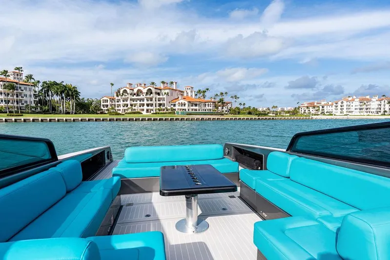 Daddy Yacht Photos Pics Luxurious 2015 VanDutch 55 yacht with turquoise seating, cruising near waterfront mansions.