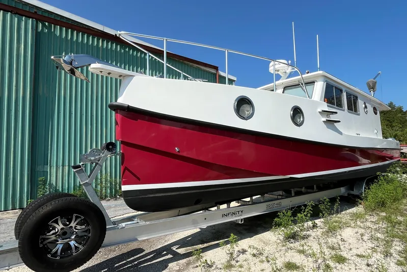 Lenore Yacht Photos Pics 2023 Great Harbour Trawlers TT35 boat on trailer, red and white design, sunny day.