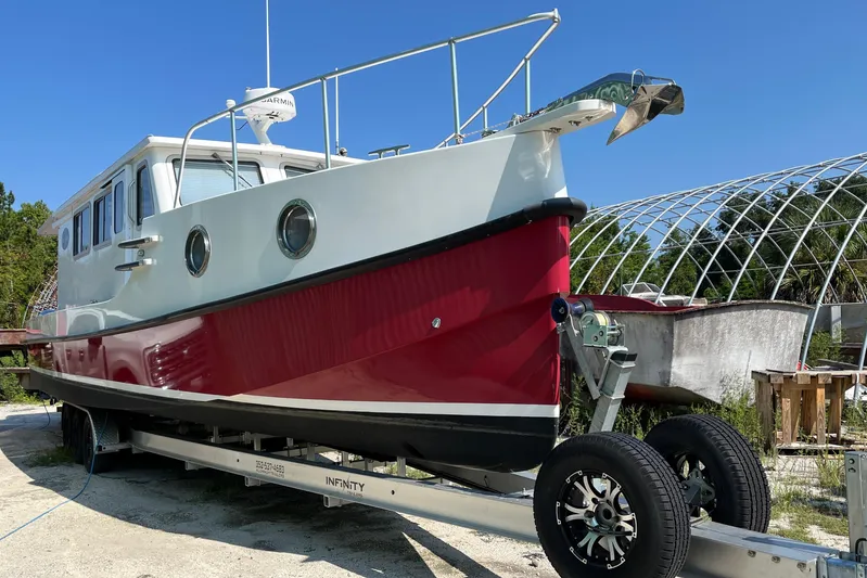 Lenore Yacht Photos Pics 2023 Great Harbour Trawlers TT35 boat on trailer, red and white design, sunny day.
