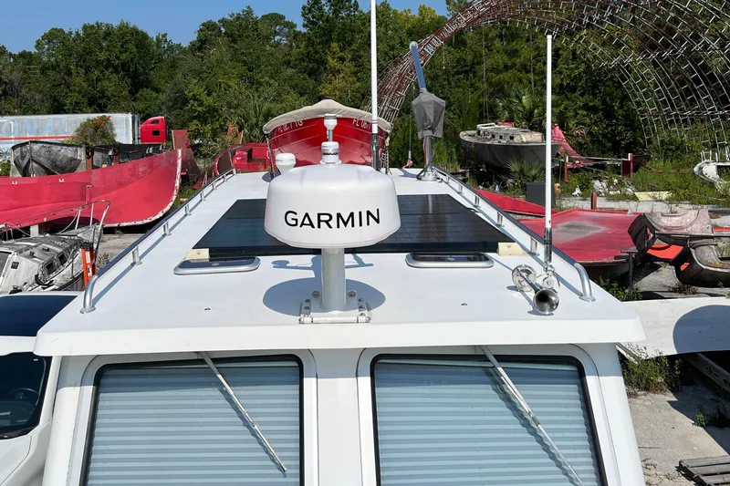 Lenore Yacht Photos Pics 2023 Great Harbour Trawlers TT35 with Garmin radar, docked among red boats.