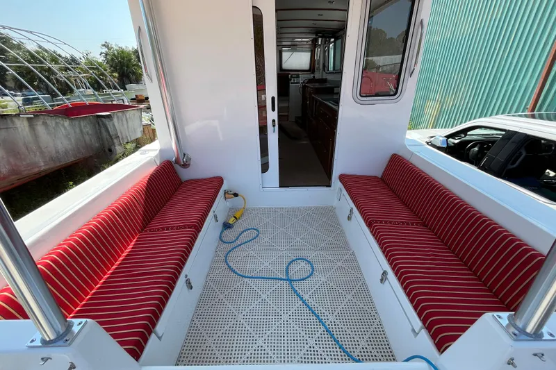 Lenore Yacht Photos Pics 2023 Great Harbour Trawlers TT35 interior with red-striped seating and spacious layout.
