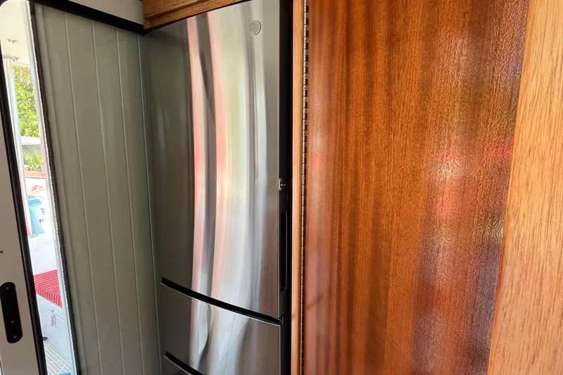Lenore Yacht Photos Pics Stainless steel refrigerator in 2023 Great Harbour Trawlers TT35 interior with wood paneling.