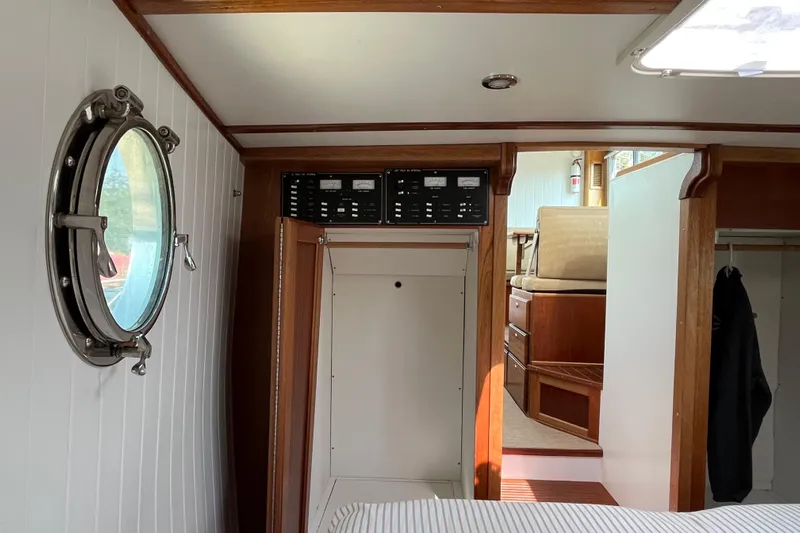 Lenore Yacht Photos Pics Interior of 2023 Great Harbour Trawlers TT35, featuring porthole and wooden cabinetry.