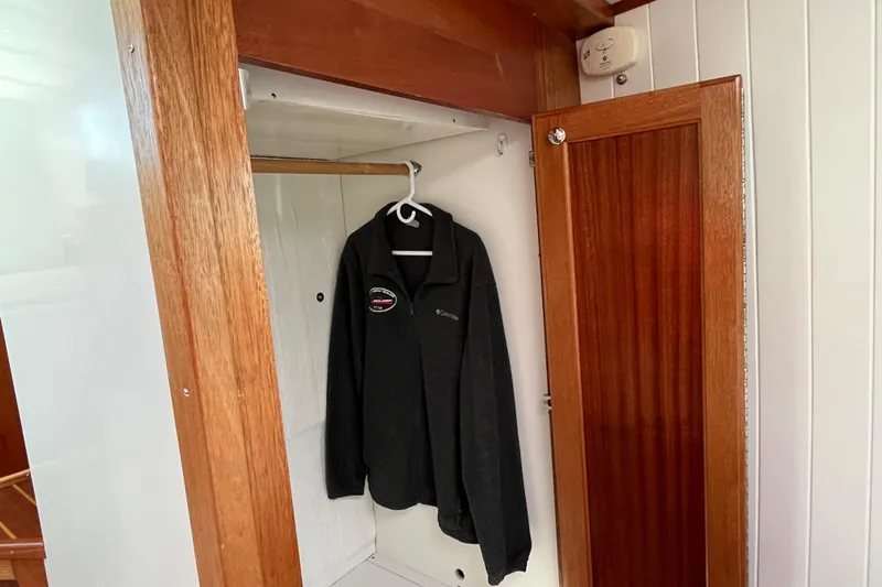 Lenore Yacht Photos Pics Wooden closet interior on 2023 Great Harbour Trawlers TT35, featuring a hanging jacket.