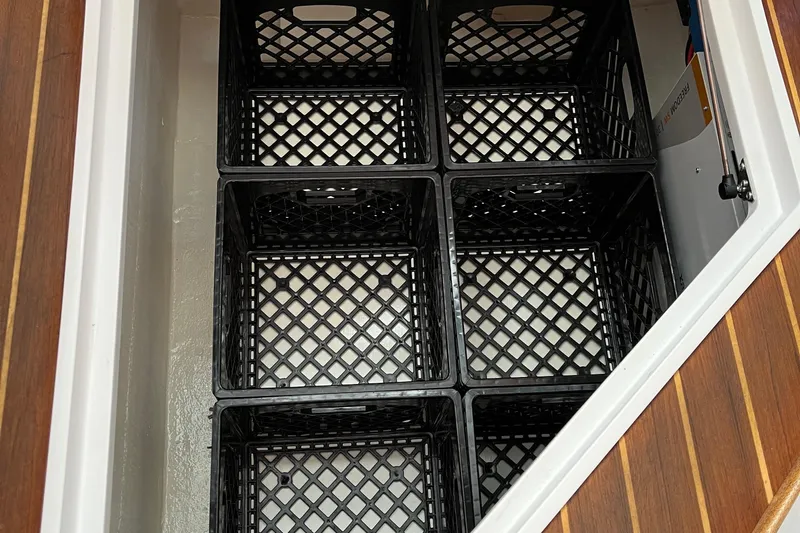 Lenore Yacht Photos Pics Storage compartment with black crates in 2023 Great Harbour TT35 boat.