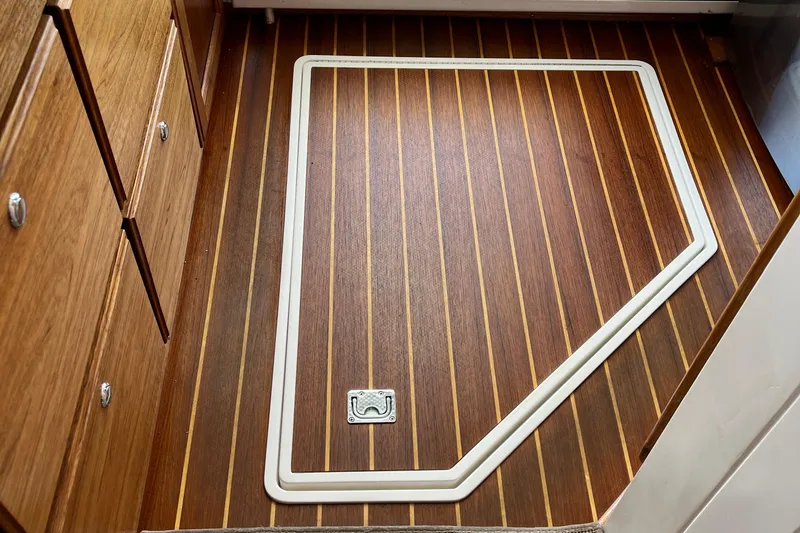 Lenore Yacht Photos Pics Wooden floor with hatch on 2023 Great Harbour TT35 boat interior.