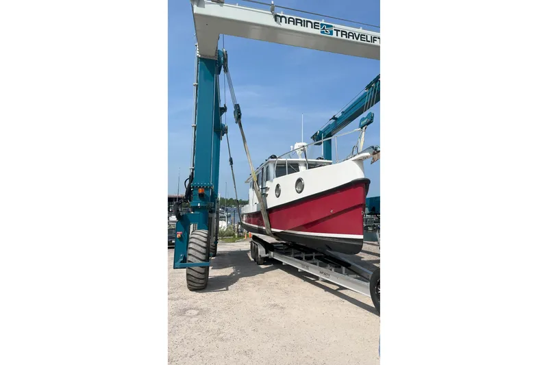 Lenore Yacht Photos Pics 2023 Great Harbour TT35 boat on a lift at a marina.