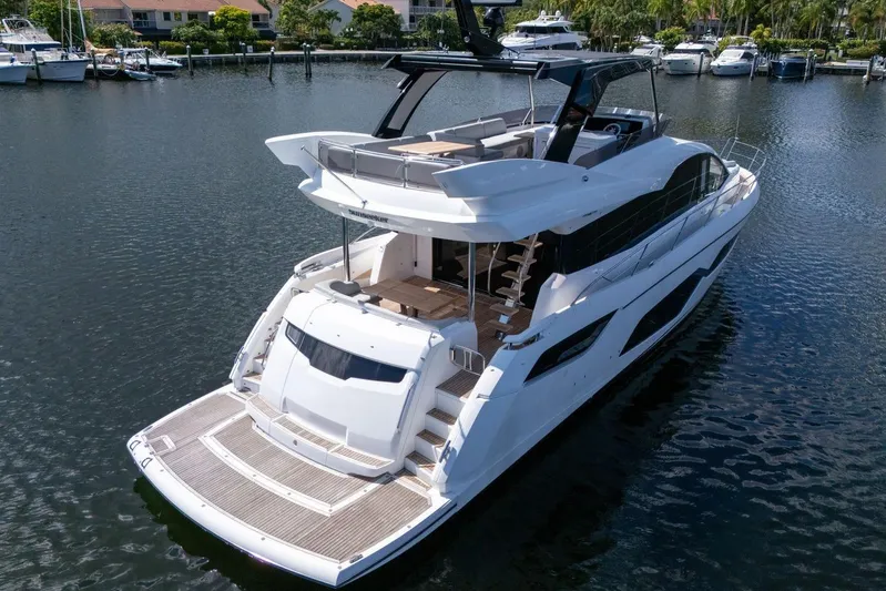  Yacht Photos Pics Luxury Sunseeker Manhattan 68 yacht, 2023 model, docked in a serene marina.