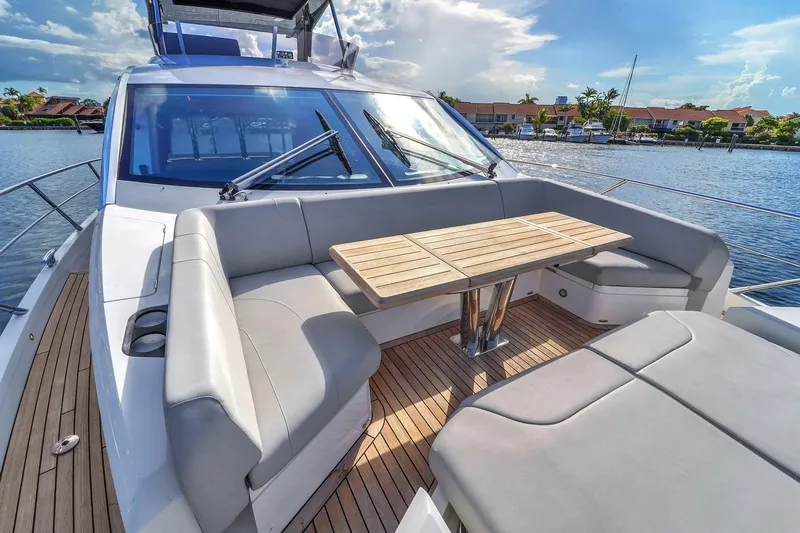  Yacht Photos Pics Luxurious 2023 Sunseeker Manhattan 68 yacht with elegant outdoor seating and table.