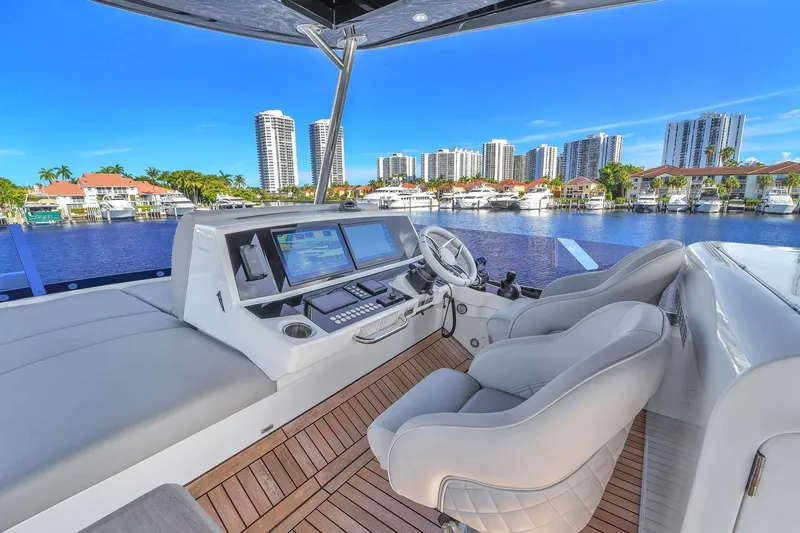  Yacht Photos Pics Luxurious 2023 Sunseeker Manhattan 68 yacht interior with modern helm and waterfront view.