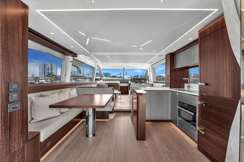  Yacht Photos Pics Luxurious interior of 2023 Sunseeker Manhattan 68 yacht with modern kitchen and dining area.