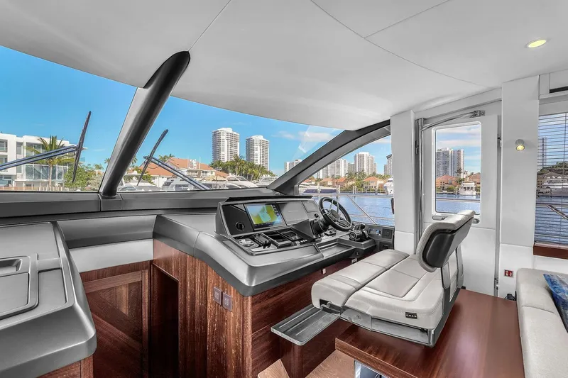  Yacht Photos Pics Luxurious interior of 2023 Sunseeker Manhattan 68 yacht with modern helm and waterfront view.