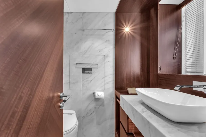  Yacht Photos Pics Luxurious bathroom in 2023 Sunseeker Manhattan 68 yacht with modern fixtures and elegant design.