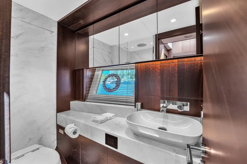  Yacht Photos Pics Luxurious bathroom in 2023 Sunseeker Manhattan 68 yacht with modern fixtures and elegant design.