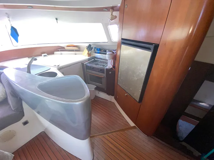 Certitude Yacht Photos Pics Interior of 1998 Fountaine Pajot Bahia 46 catamaran kitchen with wood finish and modern appliances.