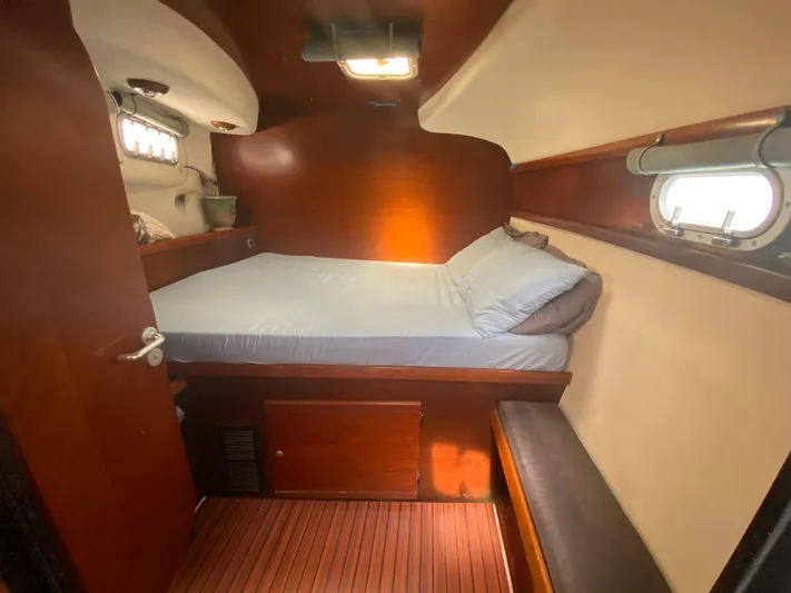 Certitude Yacht Photos Pics Cozy cabin interior of 1998 Fountaine Pajot Bahia 46 catamaran with wooden finishes.