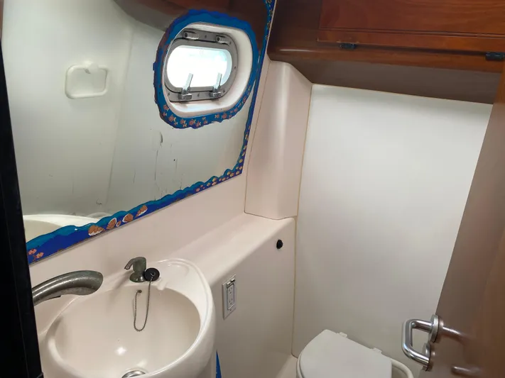 Certitude Yacht Photos Pics Bathroom interior of 1998 Fountaine Pajot Bahia 46 catamaran with sink and porthole.
