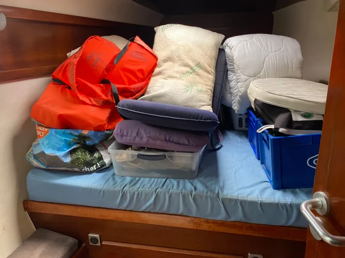 Certitude Yacht Photos Pics Cabin storage on 1998 Fountaine Pajot Bahia 46, with life jackets and cushions.