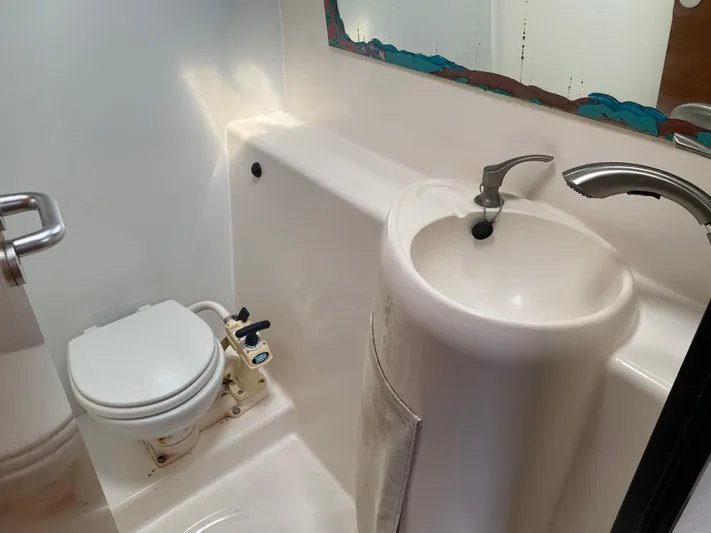 Certitude Yacht Photos Pics Bathroom interior of 1998 Fountaine Pajot Bahia 46 catamaran, featuring compact sink and toilet.