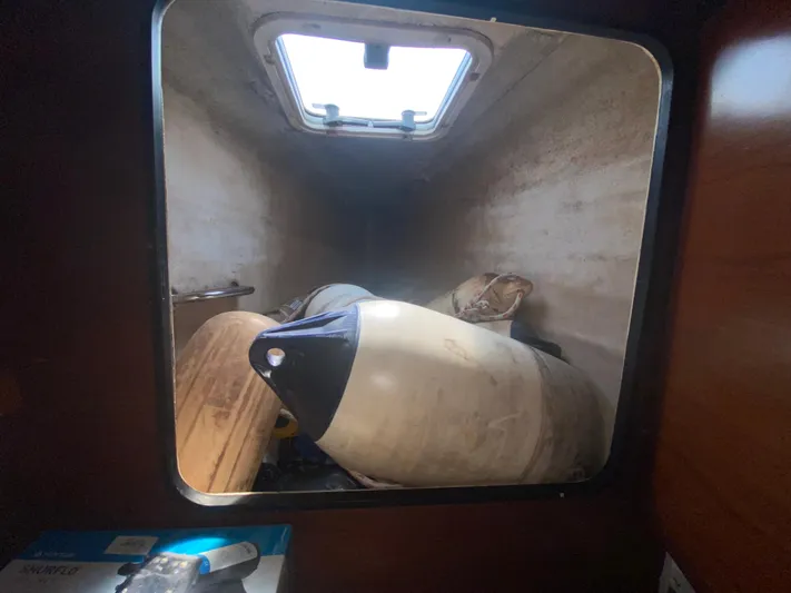 Certitude Yacht Photos Pics Storage compartment inside 1998 Fountaine Pajot Bahia 46 catamaran, containing marine equipment.