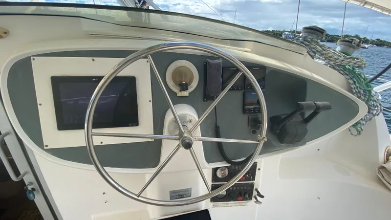 Certitude Yacht Photos Pics Helm of 1998 Fountaine Pajot Bahia 46 catamaran with steering wheel and navigation equipment.