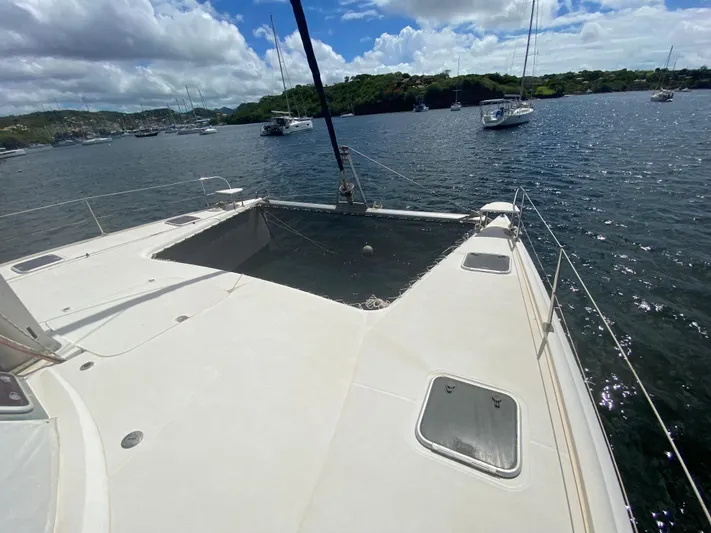 Certitude Yacht Photos Pics 1998 Fountaine Pajot Bahia 46 catamaran on calm waters, surrounded by other boats.