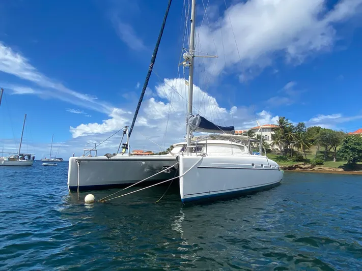 Certitude Yacht Photos Pics 1998 Fountaine Pajot Bahia 46 catamaran anchored in scenic bay with clear blue skies.