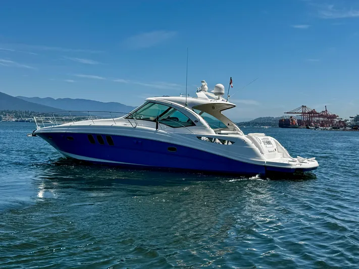 Ii-x-sessive Yacht Photos Pics 2006 Sea Ray 48 Sundancer yacht cruising on a sunny day near a port.