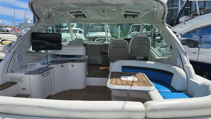 Ii-x-sessive Yacht Photos Pics 2006 Sea Ray 48 Sundancer yacht interior with seating, table, and TV in a marina setting.