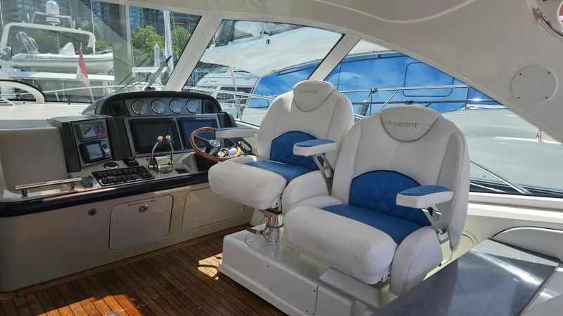 Ii-x-sessive Yacht Photos Pics 2006 Sea Ray 48 Sundancer helm with dual captain chairs and modern navigation equipment.