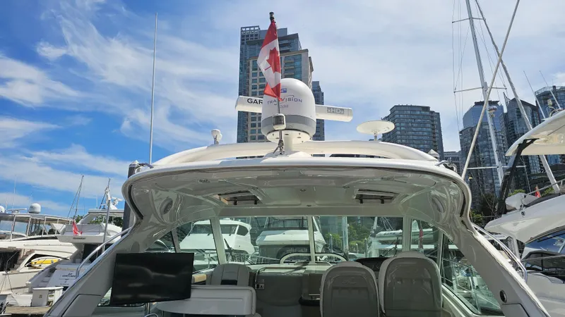 Ii-x-sessive Yacht Photos Pics 2006 Sea Ray 48 Sundancer yacht docked with city skyline in background.