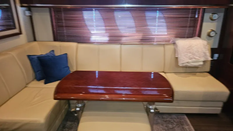 Ii-x-sessive Yacht Photos Pics Luxurious interior of 2006 Sea Ray 48 Sundancer yacht with beige seating and wooden table.