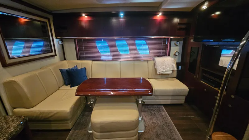Ii-x-sessive Yacht Photos Pics Luxurious interior of 2006 Sea Ray 48 Sundancer yacht with elegant seating and wooden table.