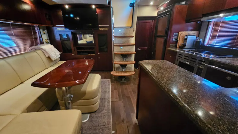 Ii-x-sessive Yacht Photos Pics Luxurious interior of 2006 Sea Ray 48 Sundancer yacht with modern kitchen and seating area.