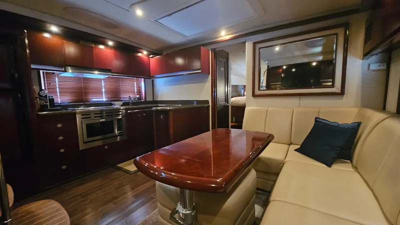 Ii-x-sessive Yacht Photos Pics Luxurious interior of 2006 Sea Ray 48 Sundancer yacht with kitchen and seating area.