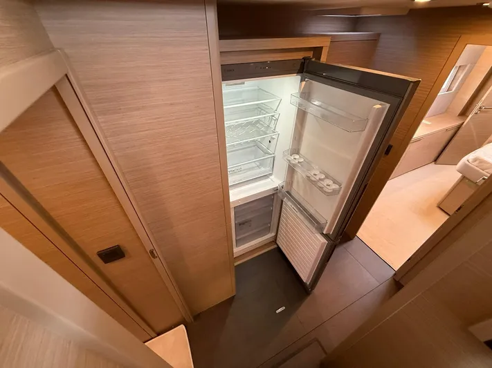  Yacht Photos Pics Modern kitchen interior of Lagoon 55 yacht, featuring an open refrigerator, 2025 model.