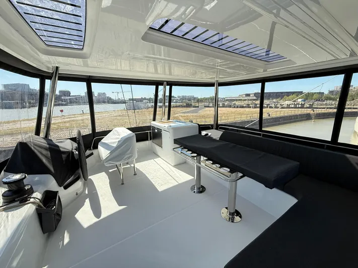  Yacht Photos Pics Spacious interior of 2025 Lagoon 55 yacht with panoramic windows and modern seating.