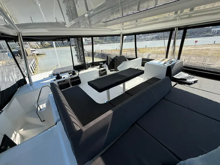 Yacht Photos Pics Luxurious interior of 2025 Lagoon 55 yacht with modern seating and panoramic windows.