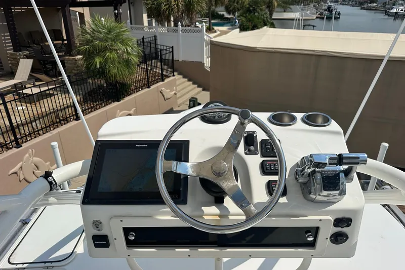  Yacht Photos Pics 2013 Boston Whaler 370 Outrage helm with steering wheel and navigation system.