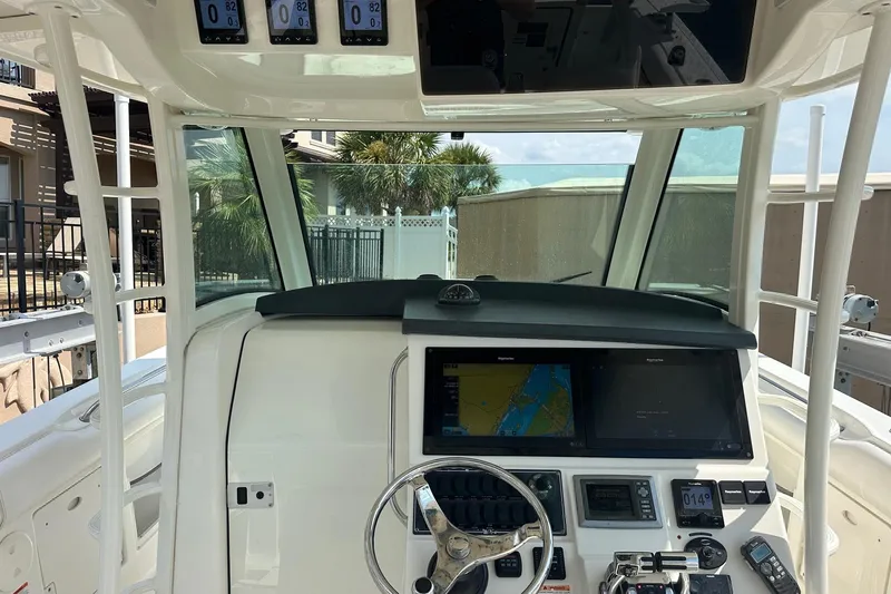  Yacht Photos Pics 2013 Boston Whaler 370 Outrage helm with navigation screens and controls.