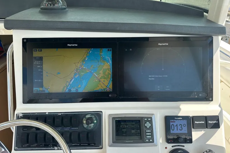  Yacht Photos Pics Boston Whaler 370 Outrage 2013 dashboard with Raymarine navigation displays and controls.
