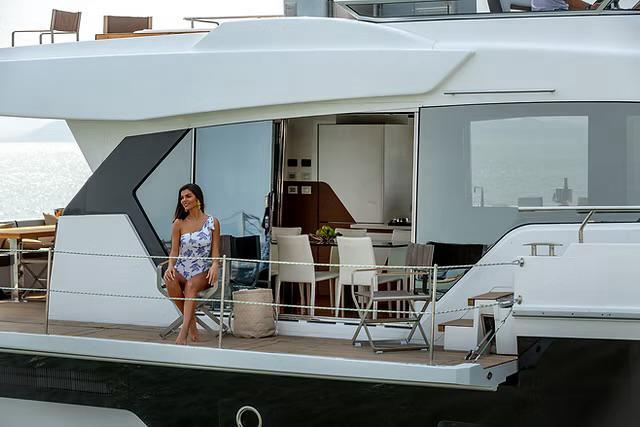 Luxury yacht Schaefer 770, 2026 model, with a woman enjoying the deck.