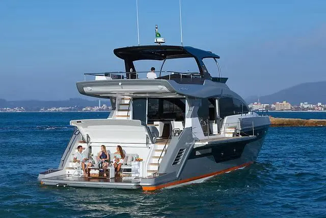  Yacht Photos Pics Luxury Schaefer 770 yacht cruising on the ocean, 2026 model, with people relaxing on deck.