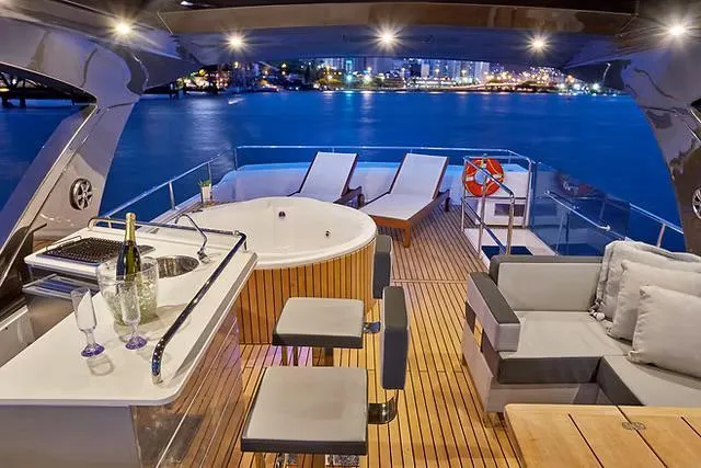  Yacht Photos Pics Luxurious Schaefer 770 yacht deck with jacuzzi, bar, and city skyline view, 2026 model.