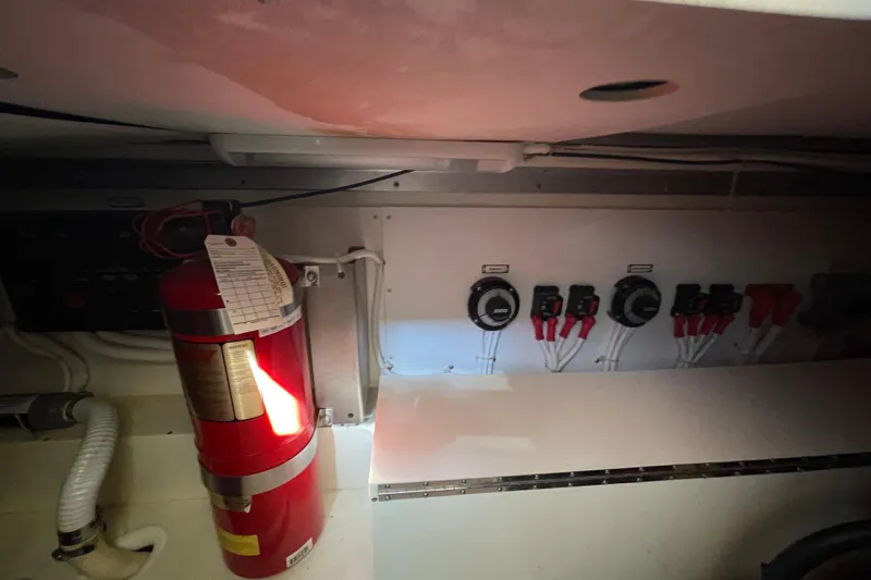 Tax Sea Vasion Yacht Photos Pics 2003 Carver 36 Sport Sedan engine room with fire extinguisher and control panel.