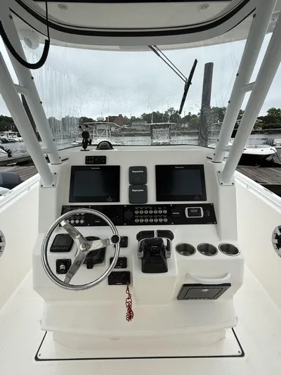  Yacht Photos Pics 2015 Edgewater 280CC boat dashboard with steering wheel and navigation screens.