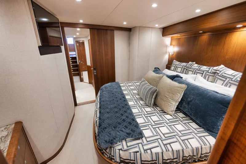 Artemis Yacht Photos Pics Luxurious bedroom interior of 2020 Merritt 77 Sportfish Convertible yacht with elegant bedding.